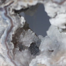Load image into Gallery viewer, Close-up of a crystal formation with a central dark area