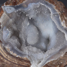 Load image into Gallery viewer, Close-up of a geode with crystal formations inside
