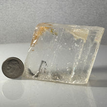 Load image into Gallery viewer, Clear crystal block with a coin for scale on a gray background