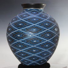 Load image into Gallery viewer, Decorative vase with blue and black geometric pattern on a gradient background