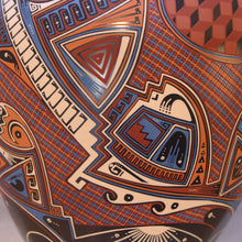 Load image into Gallery viewer, Close-up of a ceramic vase with intricate geometric and abstract patterns in red, blue, and brown.