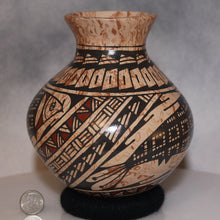 Load image into Gallery viewer, Coin next to Mata Ortiz Pottery