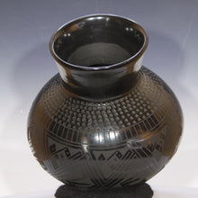 Load image into Gallery viewer, Black ceramic vase with geometric patterns on a gray background