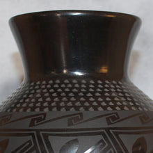 Load image into Gallery viewer, Close-up of a black ceramic vase with geometric patterns on a white background
