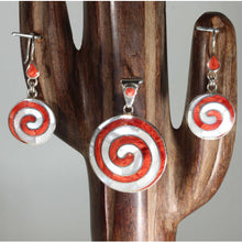 Load image into Gallery viewer, A set of jewelry including a red and white spiral design pendant and a pair of matching earrings, displayed on a wooden stand.