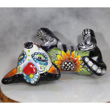 Load image into Gallery viewer, Decorative ceramic pieces with colorful designs on its back a gray background