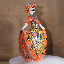 Load image into Gallery viewer, Colorful ceramic figure with intricate designs on a brown background