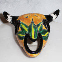 Load image into Gallery viewer, Decorative cow skull with black horns and green leaf design on a white background