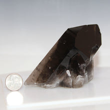 Load image into Gallery viewer, Smoky crystal with a dime for scale on a white background
