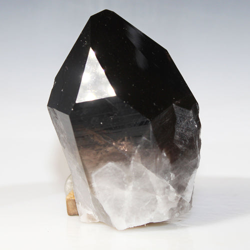 Crystal with black and clear sections on a white background