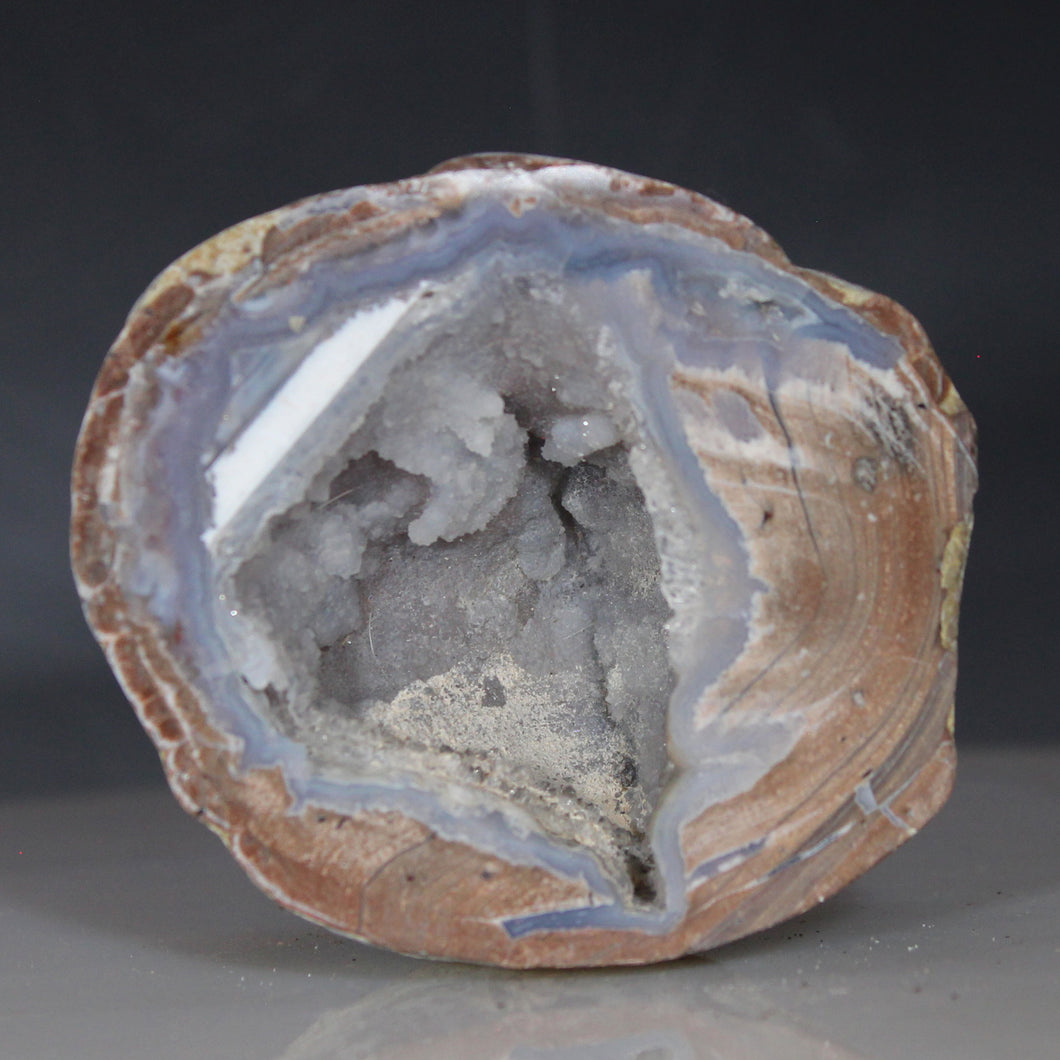 Geode with a rough, natural surface on a gray background Dugway Geode Deep Chamber