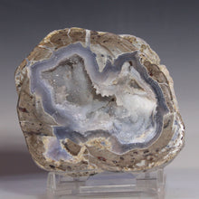 Load image into Gallery viewer, Geode with internal crystal structure on a gray background
