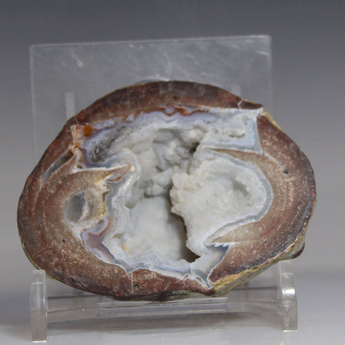 Blue Dugway Geode Stepped Chamber on a clear stand against a gray background