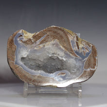 Load image into Gallery viewer, Geode crystal on a stand against a gray background
