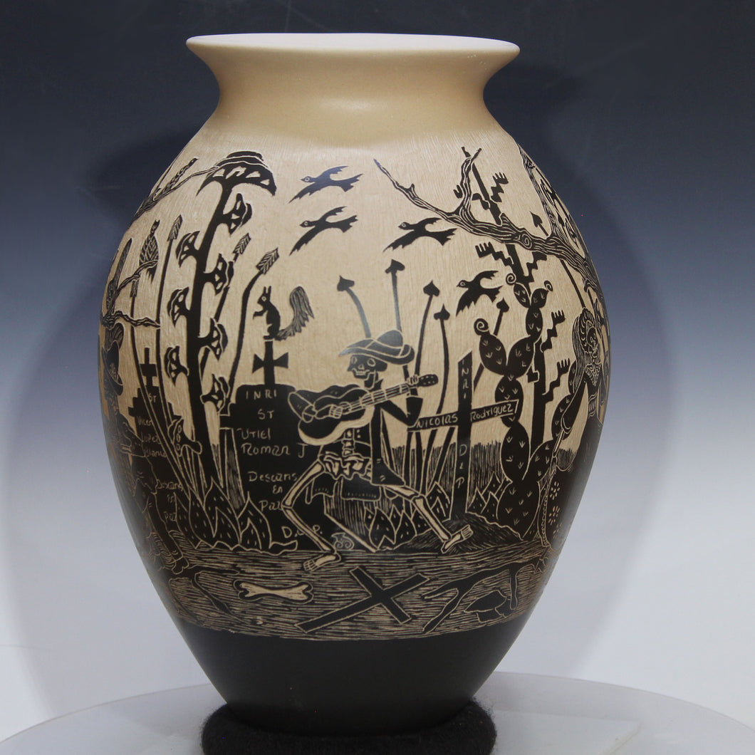 Decorative vase with black silhouette designs on a beige background