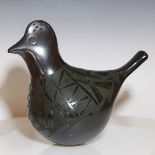 Ceramic bird sculpture with geometric patterns on a white background