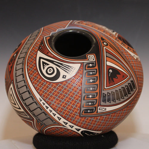 Decorative ceramic vase with intricate patterns on a neutral background