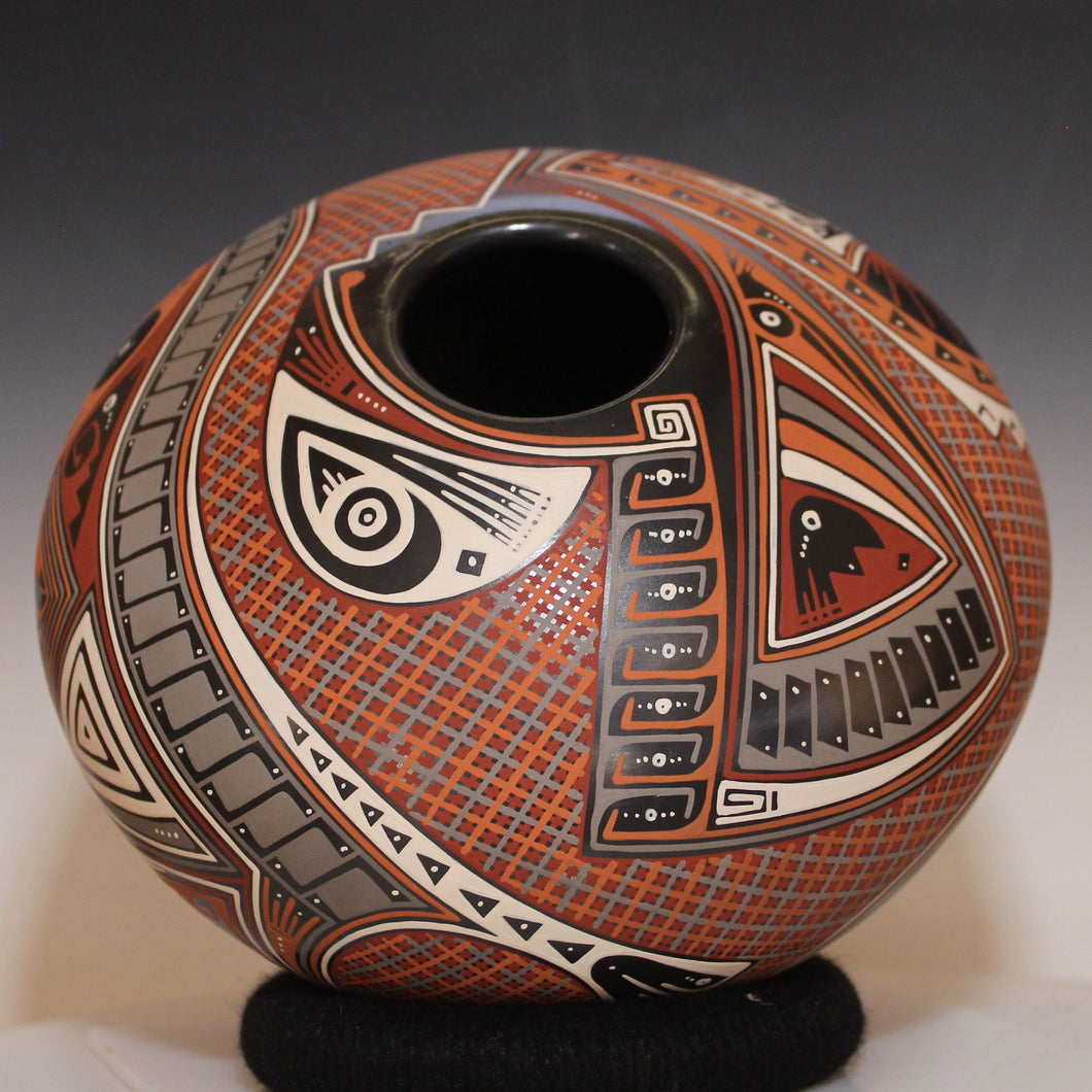 Decorative ceramic vase with intricate patterns on a neutral background
