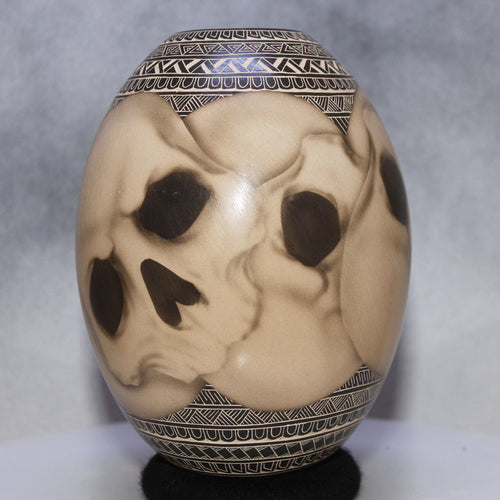 Decorative ceramic urn with intricate patterns on a gray background
