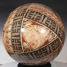 Load image into Gallery viewer, Decorative sphere with intricate patterns on a dark background
