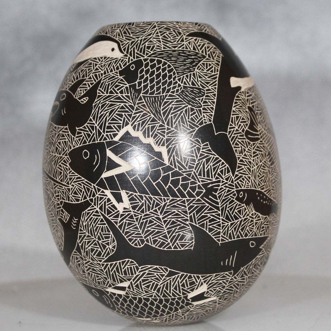Decorative vase with black and white fish pattern on a gray background