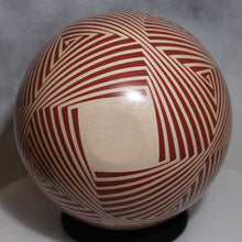 Load image into Gallery viewer, Decorative sphere with red and white pattern on a gray background with artists signature
