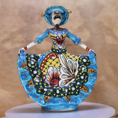 Colorful ceramic figurine with butterfly design on a beige background