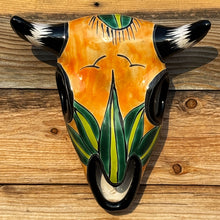 Load image into Gallery viewer, Decorative wall art of a bull skull with colorful design on a wooden background
