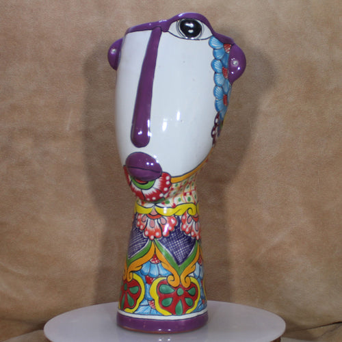 Colorful ceramic vase with abstract design on a beige background