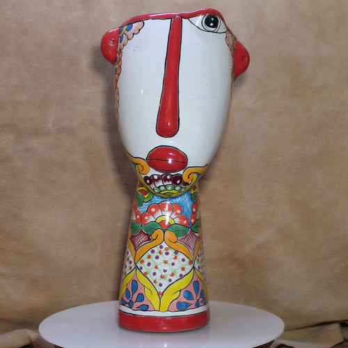 Colorful ceramic vase with abstract design on a beige background